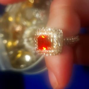 A very pretty ring  looks orange with white stones